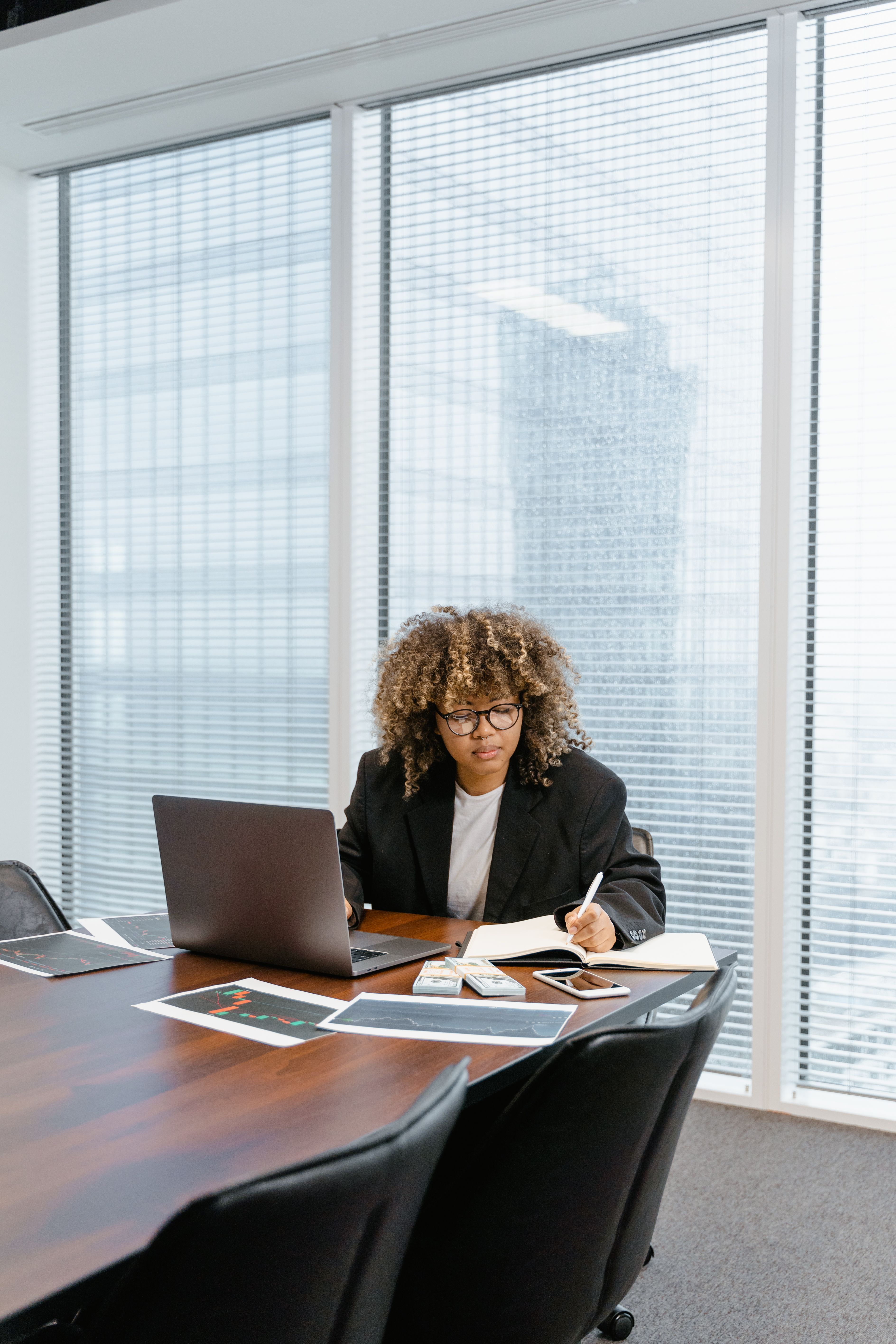 Professional woman reviewing documents at a conference table
